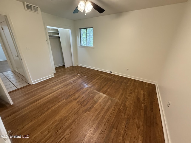 1632 Winchester St, Jackson, MS 39211 - unfurnished bedroom featuring dark wood-style flooring, baseboards, a closet, and a ceiling fan