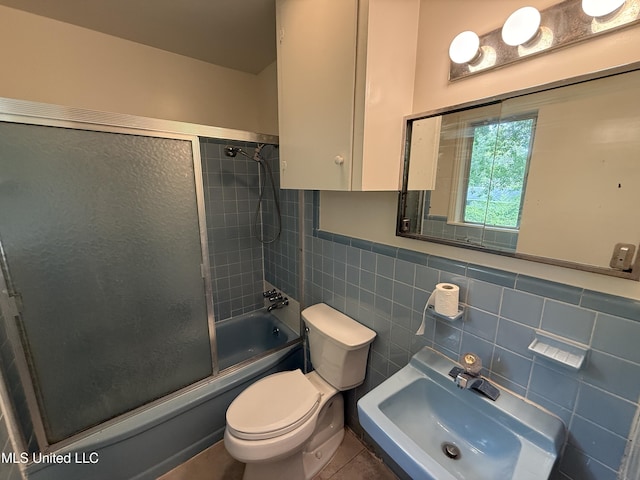 1632 Winchester St, Jackson, MS 39211 - full bath featuring a sink, toilet, tile walls, enclosed tub / shower combo, and a wainscoted wall