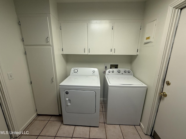 1632 Winchester St, Jackson, MS 39211 - laundry room with cabinet space, washing machine and dryer, and light tile patterned floors
