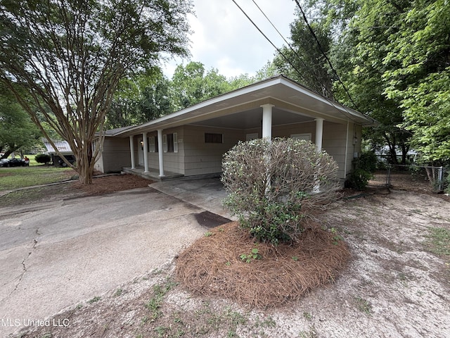 1632 Winchester St, Jackson, MS 39211 - view of front facade featuring a carport, driveway, and fence