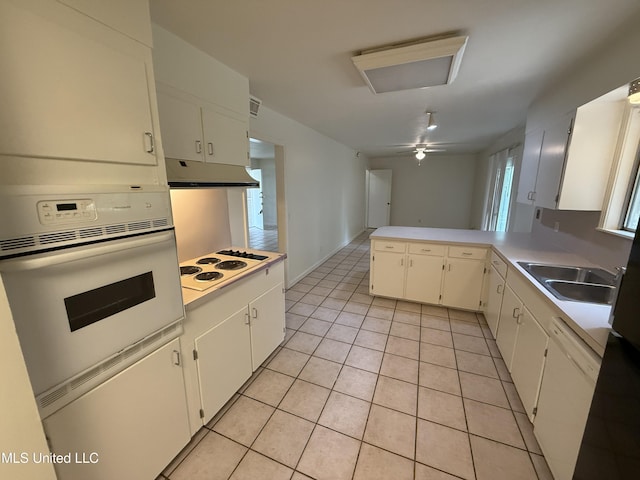 1632 Winchester St, Jackson, MS 39211 - kitchen featuring white appliances, under cabinet range hood, light countertops, and light tile patterned floors