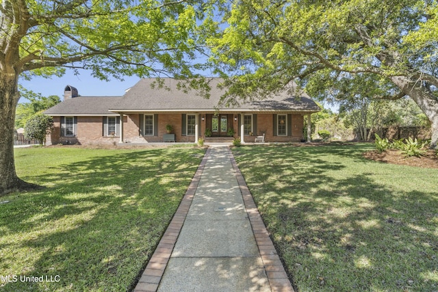 2629 Park View Dr, Biloxi, MS 39531 - view of front of home featuring a porch, brick siding, a chimney, and a front yard