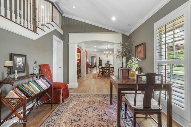 2629 Park View Dr, Biloxi, MS 39531 - dining area featuring arched walkways, decorative columns, wood finished floors, ornamental molding, and a chandelier