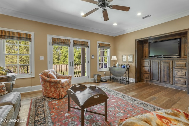 2629 Park View Dr, Biloxi, MS 39531 - living area with wood finished floors, plenty of natural light, ceiling fan, french doors, and crown molding
