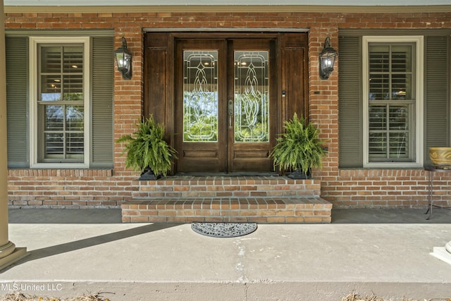 2629 Park View Dr, Biloxi, MS 39531 - view of exterior entry featuring french doors, brick siding, and covered porch