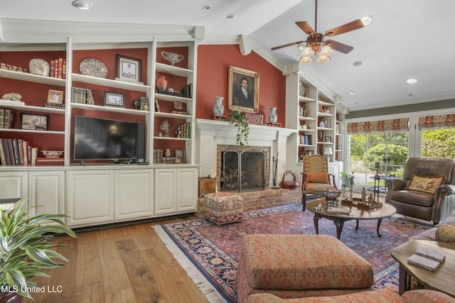 2629 Park View Dr, Biloxi, MS 39531 - living room featuring light wood-style floors, a ceiling fan, crown molding, vaulted ceiling, and a brick fireplace