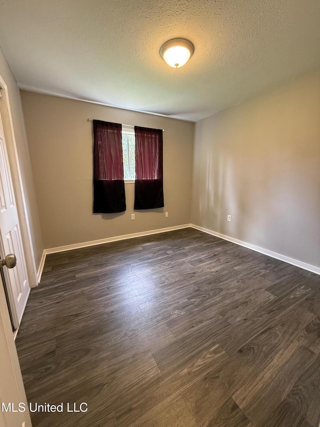 448 Ruston St, Pearl, MS 39208 - spare room featuring dark wood-style flooring and a textured ceiling
