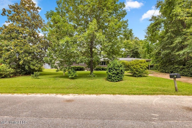 615 Baker St, Wiggins, MS 39577 - view of property hidden behind natural elements with a front yard