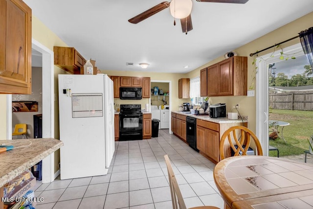 615 Baker St, Wiggins, MS 39577 - kitchen featuring black appliances, light tile patterned floors, light countertops, independent washer and dryer, and ceiling fan