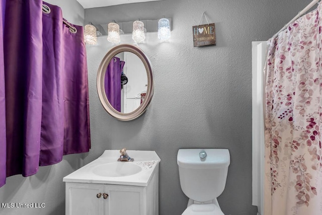 615 Baker St, Wiggins, MS 39577 - bathroom featuring vanity, toilet, and a shower with shower curtain