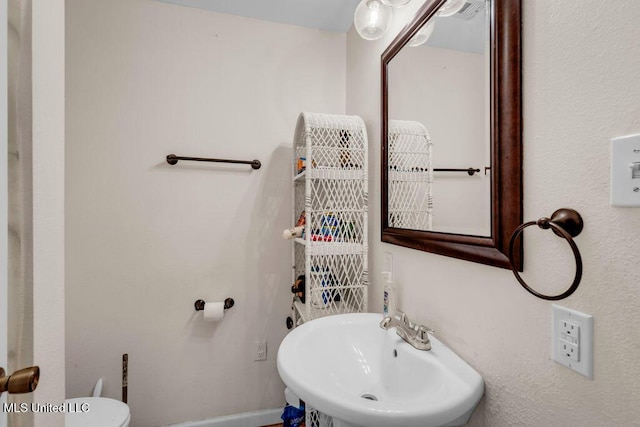 615 Baker St, Wiggins, MS 39577 - bathroom with a sink, toilet, and baseboards