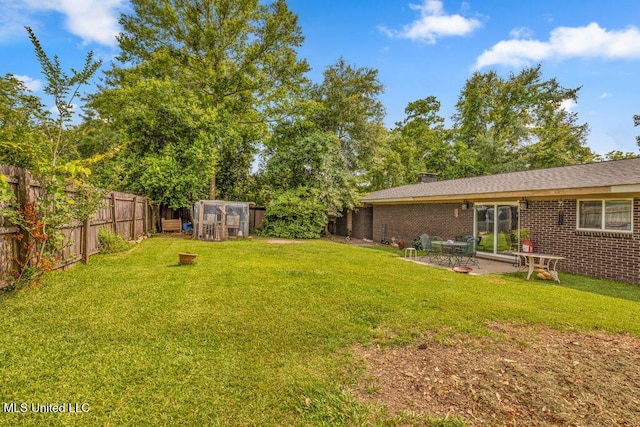 615 Baker St, Wiggins, MS 39577 - view of yard with an exterior structure, an outbuilding, and a patio area