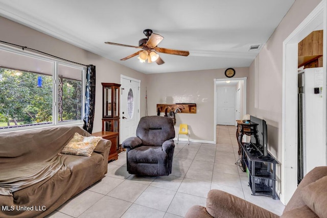 615 Baker St, Wiggins, MS 39577 - living area featuring light tile patterned floors, a ceiling fan, and baseboards