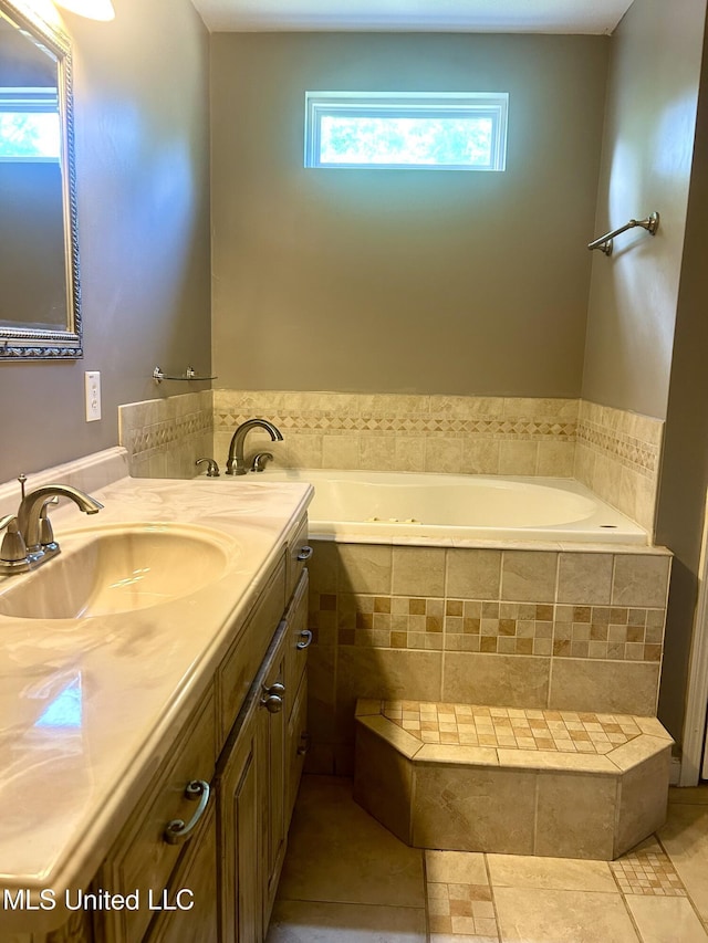full bath with tile patterned floors, vanity, and a bath