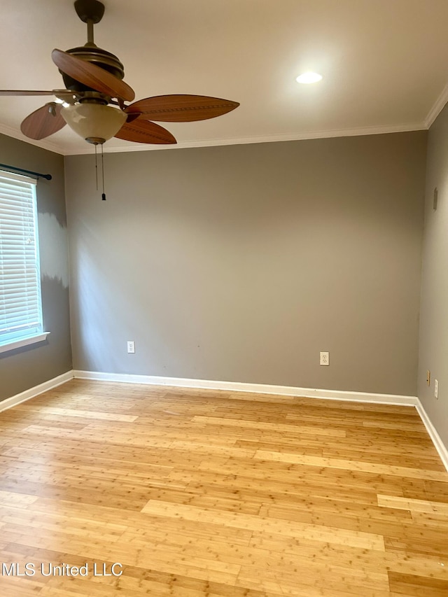 empty room with light wood-style flooring, ceiling fan, and crown molding