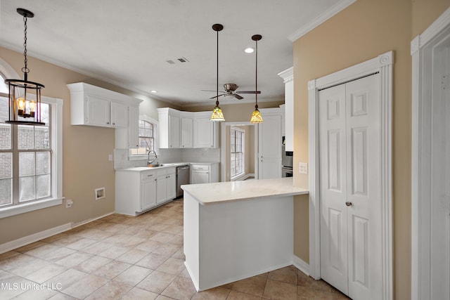 kitchen with appliances with stainless steel finishes, white cabinets, light countertops, and a peninsula