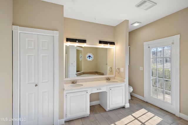 full bathroom featuring a closet, visible vents, and a sink