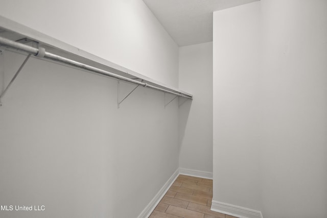 walk in closet featuring wood finish floors