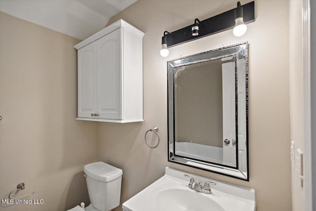 bathroom featuring toilet and a sink