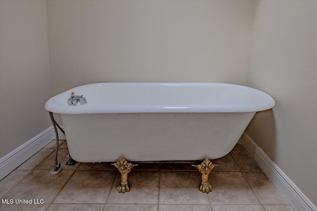 interior details featuring baseboards and a freestanding bath