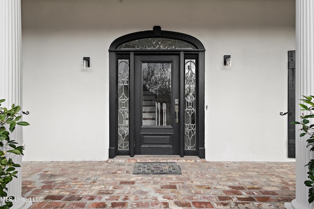 doorway to property with stucco siding