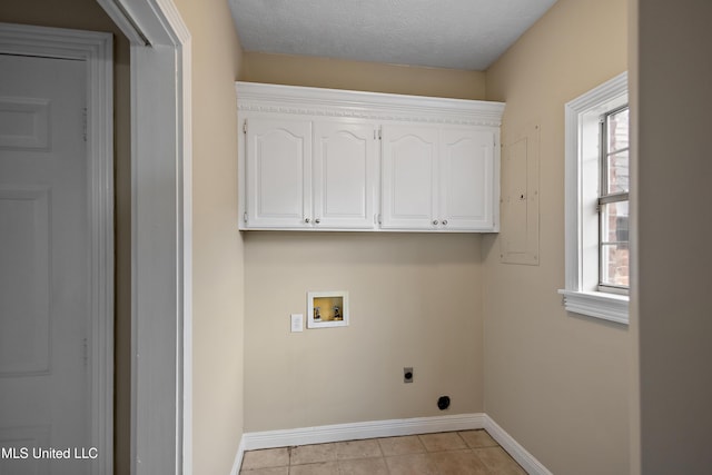 clothes washing area featuring light tile patterned floors, a textured ceiling, hookup for a washing machine, baseboards, and electric dryer hookup