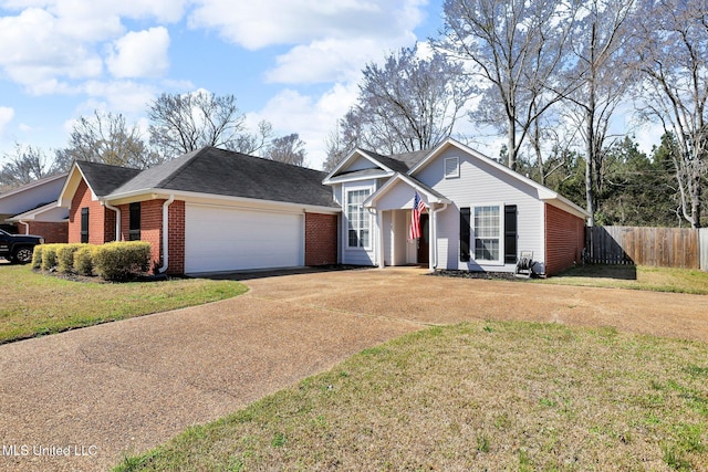 view of front of property with a front yard, fence, an attached garage, concrete driveway, and brick siding