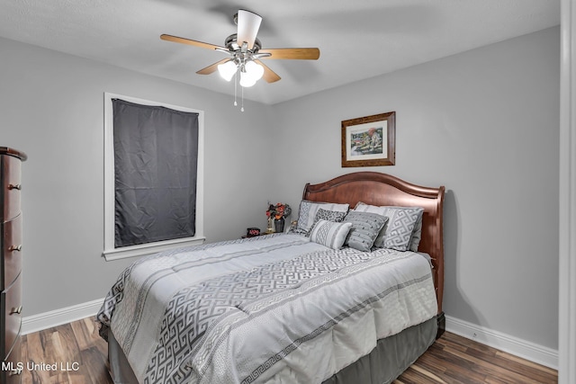 bedroom with ceiling fan, baseboards, and wood finished floors