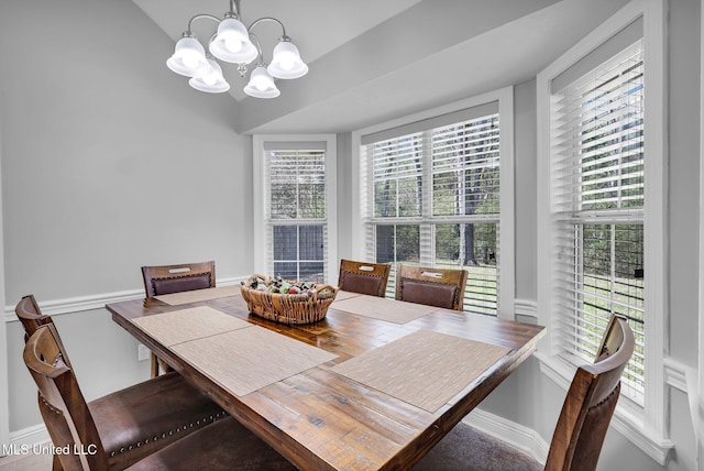 dining room featuring baseboards and an inviting chandelier