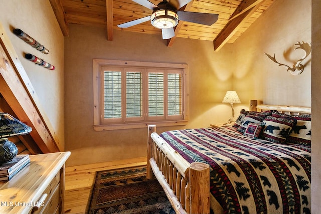 bedroom featuring ceiling fan, wood-type flooring, beam ceiling, and wooden ceiling