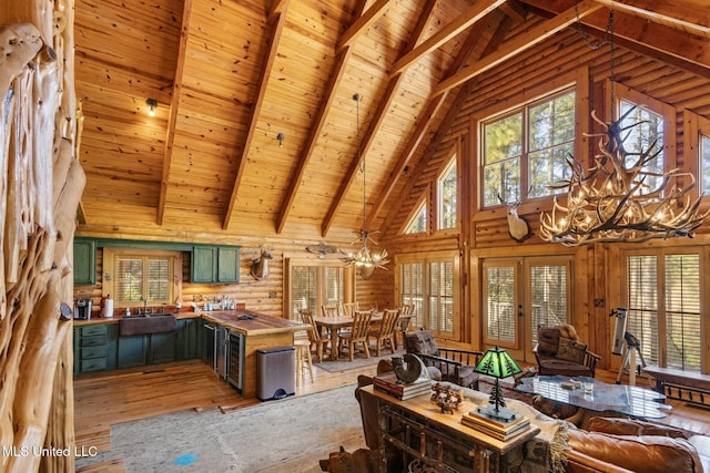 home office featuring wood ceiling, a notable chandelier, beverage cooler, beamed ceiling, and light wood-type flooring