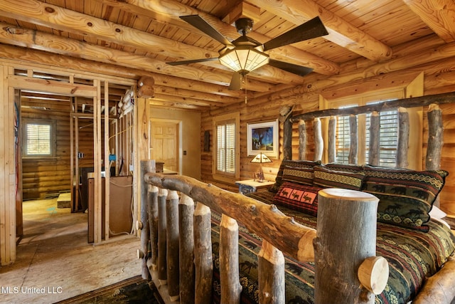interior space featuring wood ceiling, beam ceiling, and rustic walls