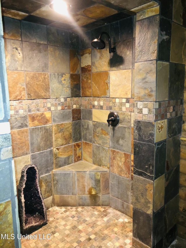 bathroom with a tile shower