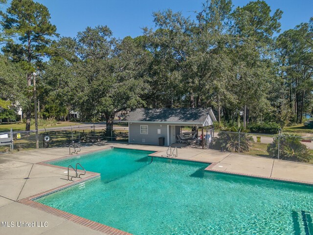 6533 Shawnee St, Kiln, MS 39556 - pool with a patio and fence