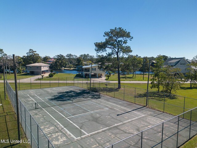 6533 Shawnee St, Kiln, MS 39556 - view of sport court featuring a lawn, fence, and a water view