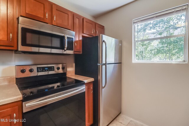 6533 Shawnee St, Kiln, MS 39556 - kitchen featuring brown cabinets, stainless steel appliances, and light countertops