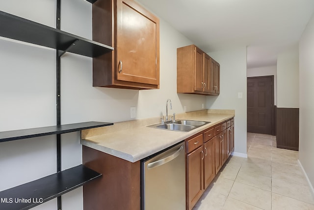 kitchen featuring dishwasher, sink, and light tile patterned floors