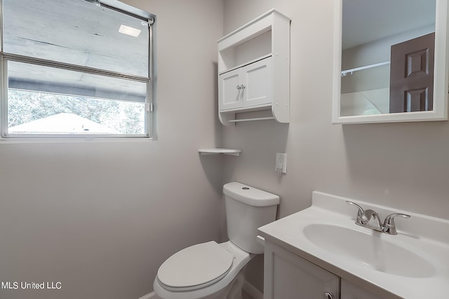 bathroom featuring toilet and vanity