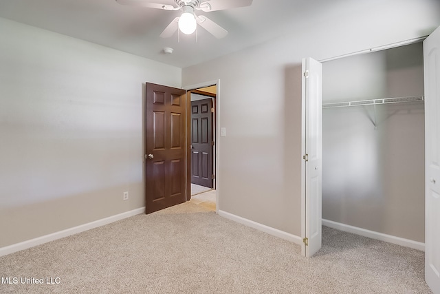 unfurnished bedroom featuring light carpet, a closet, and ceiling fan