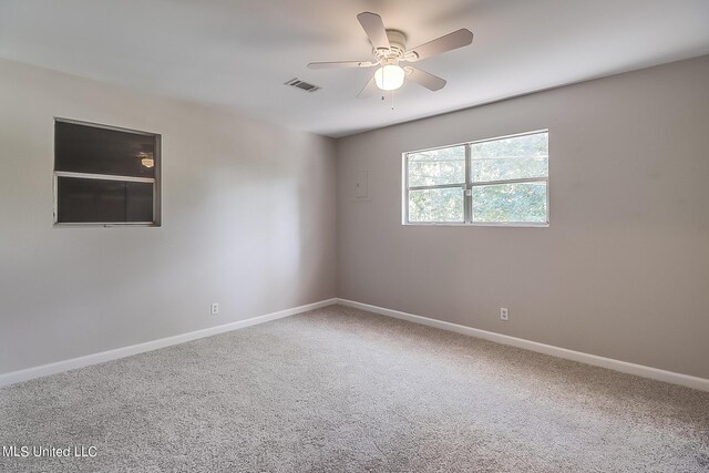 6533 Shawnee St, Kiln, MS 39556 - carpeted spare room featuring visible vents, a ceiling fan, and baseboards