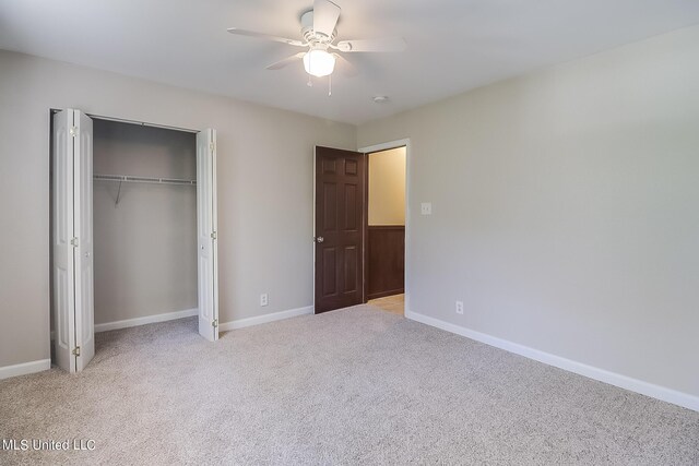 6533 Shawnee St, Kiln, MS 39556 - unfurnished bedroom with a ceiling fan, baseboards, light carpet, and a closet