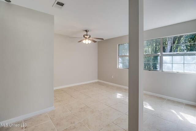 6533 Shawnee St, Kiln, MS 39556 - empty room with visible vents, baseboards, ceiling fan, and light tile patterned floors