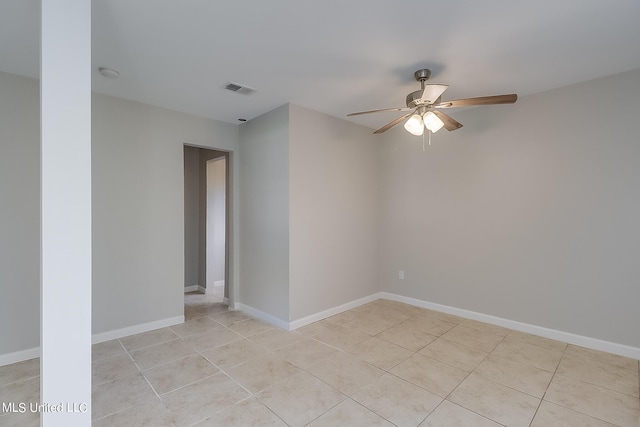 tiled empty room featuring ceiling fan