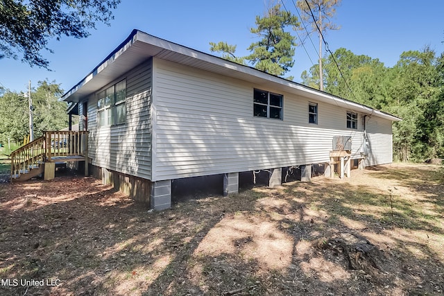 view of home's exterior featuring a wooden deck