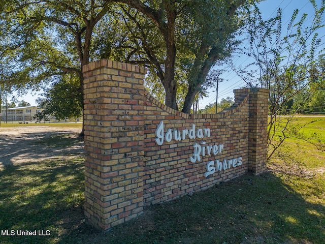 community / neighborhood sign featuring a yard