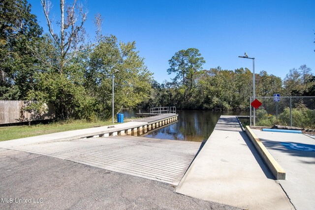6533 Shawnee St, Kiln, MS 39556 - dock area featuring a water view and fence