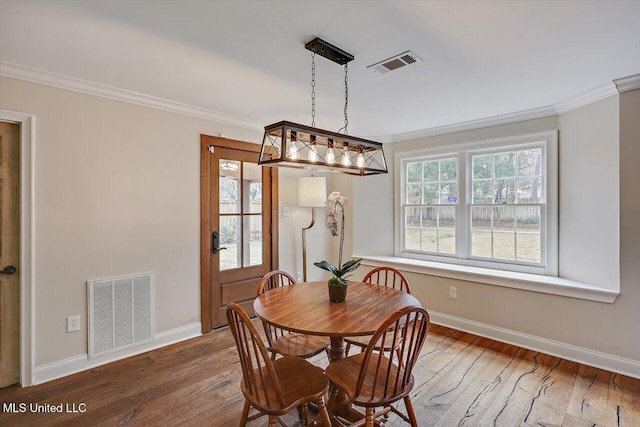 dining room with ornamental molding, dark hardwood / wood-style floors, and a wealth of natural light