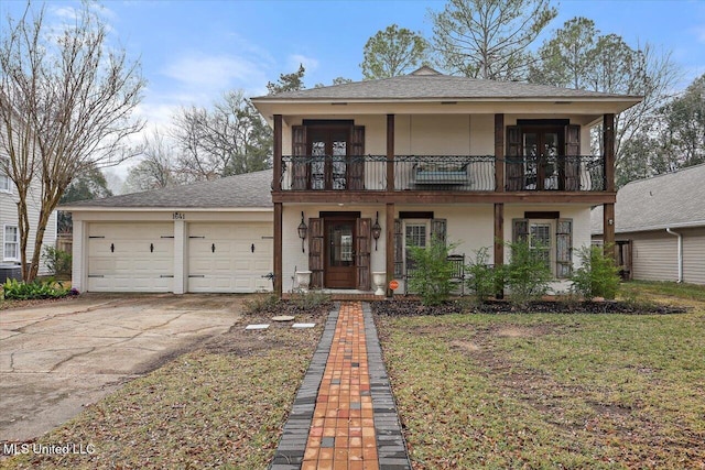 view of front of property with a garage, central AC, and a front lawn