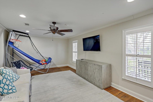 living room with crown molding, ceiling fan, and wood-type flooring