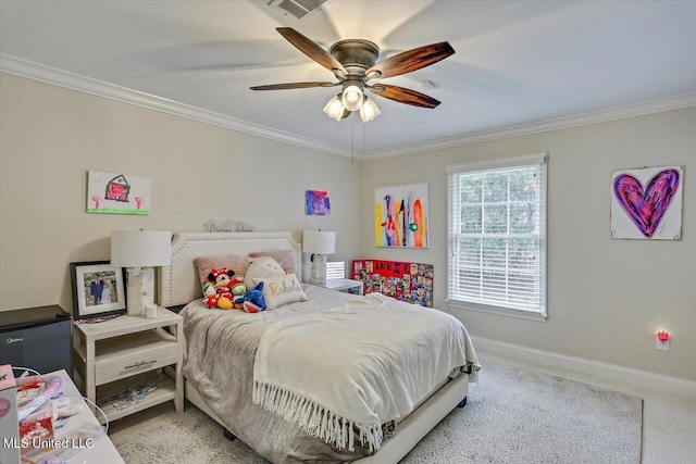 carpeted bedroom with ornamental molding and ceiling fan